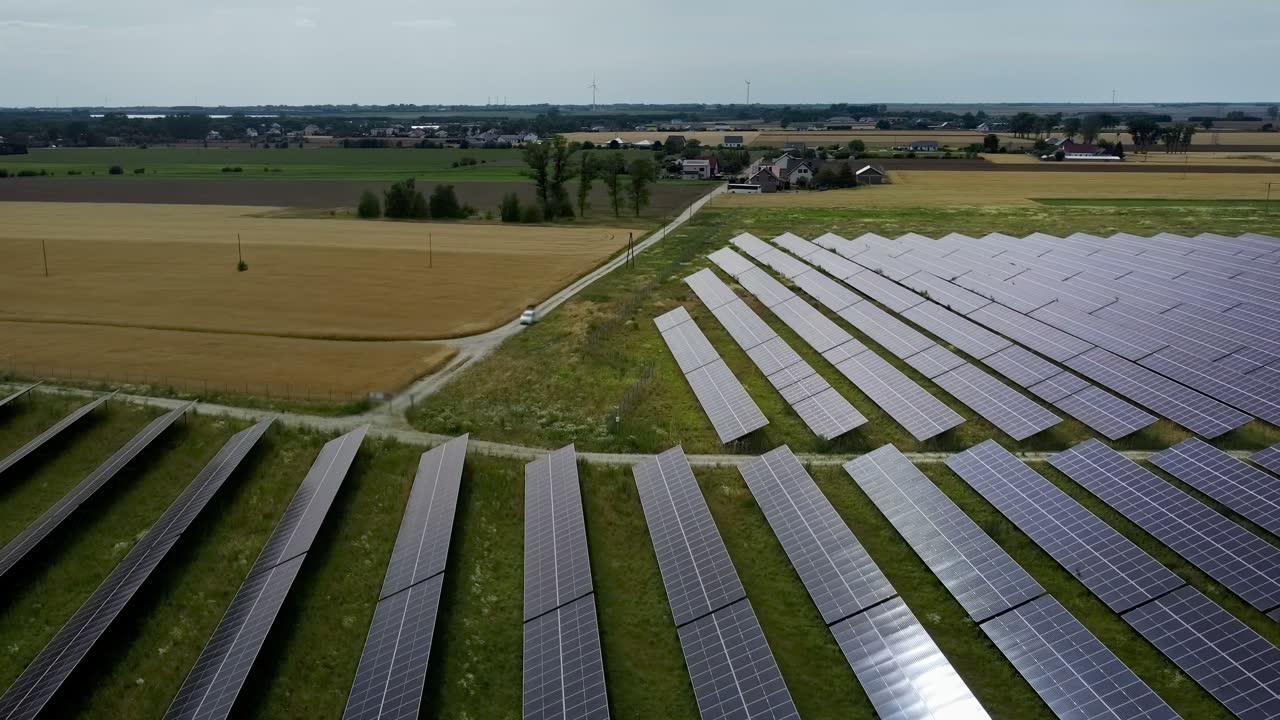 Aerial view of a wind and solar farm with data overlay showing real-time monitoring metrics.